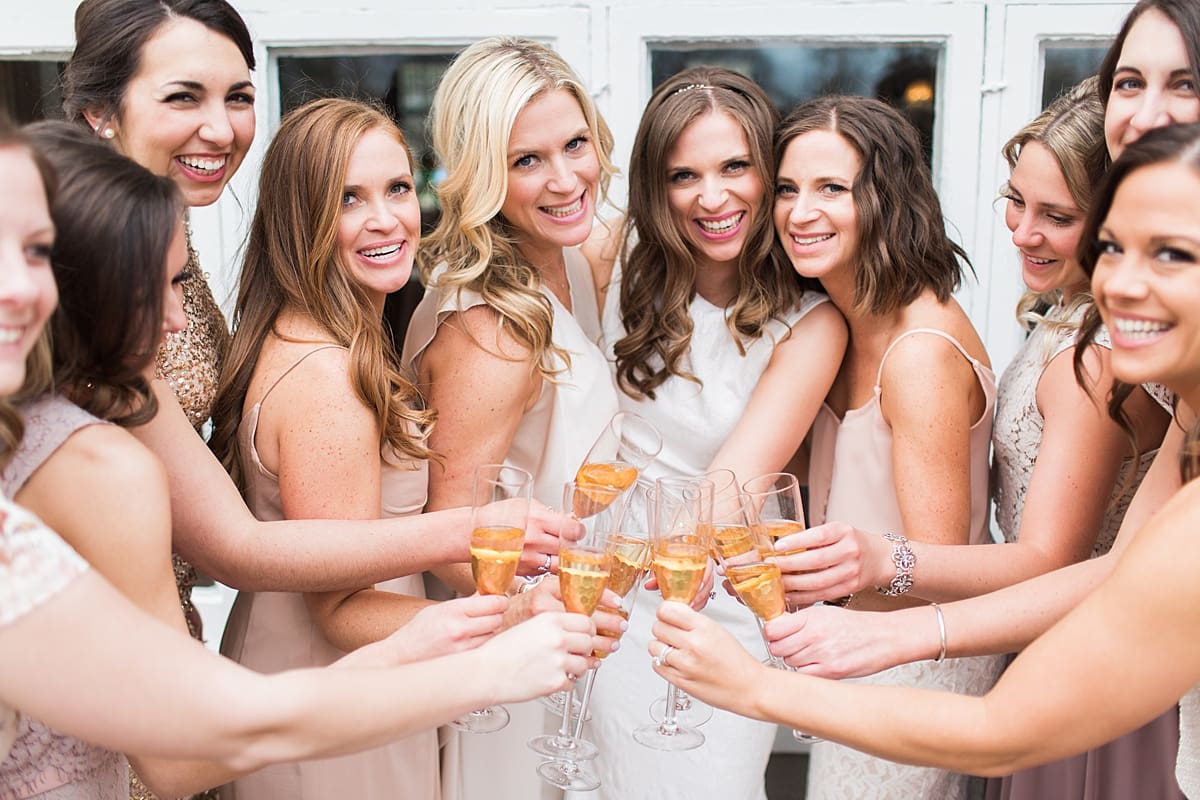 Arielle Peters Photography | Bride and bridesmaids drinking champagne on wedding day at the Basilica of the Sacred Heart in Notre Dame, Indiana.