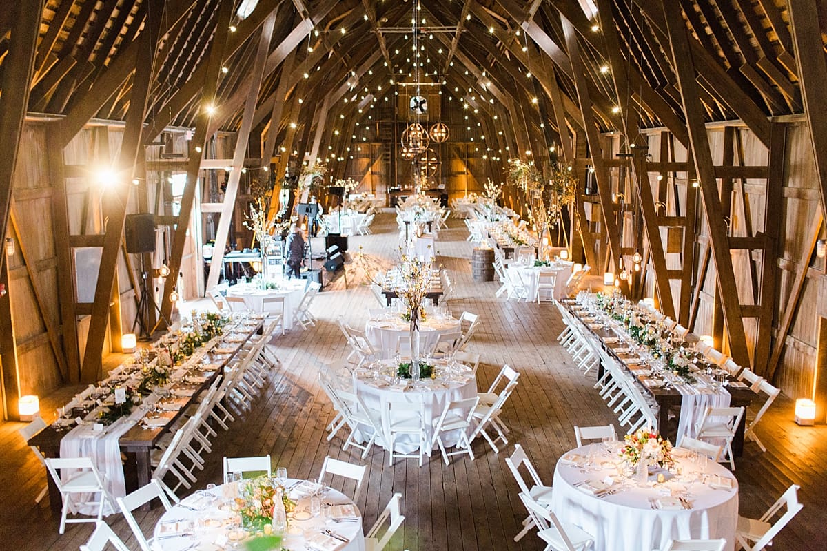 Arielle Peters Photography | Barn wedding reception table settings and floral arrangements on wedding day at St. Joseph's Farm in Granger, Indiana.