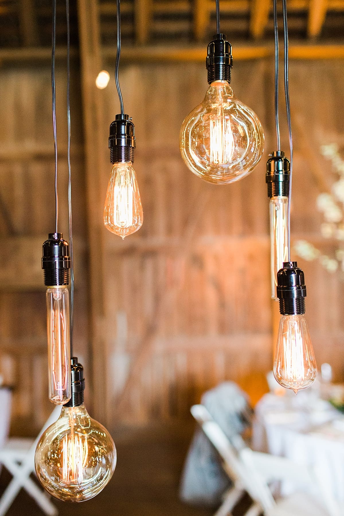 Arielle Peters Photography | Barn wedding reception table settings and floral arrangements on wedding day at St. Joseph's Farm in Granger, Indiana.