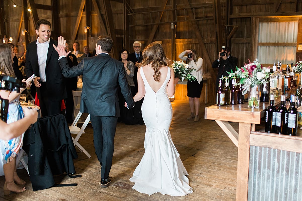 Arielle Peters Photography | Bride and groom entering wedding reception on wedding day at St. Joseph's Farm in Granger, Indiana.
