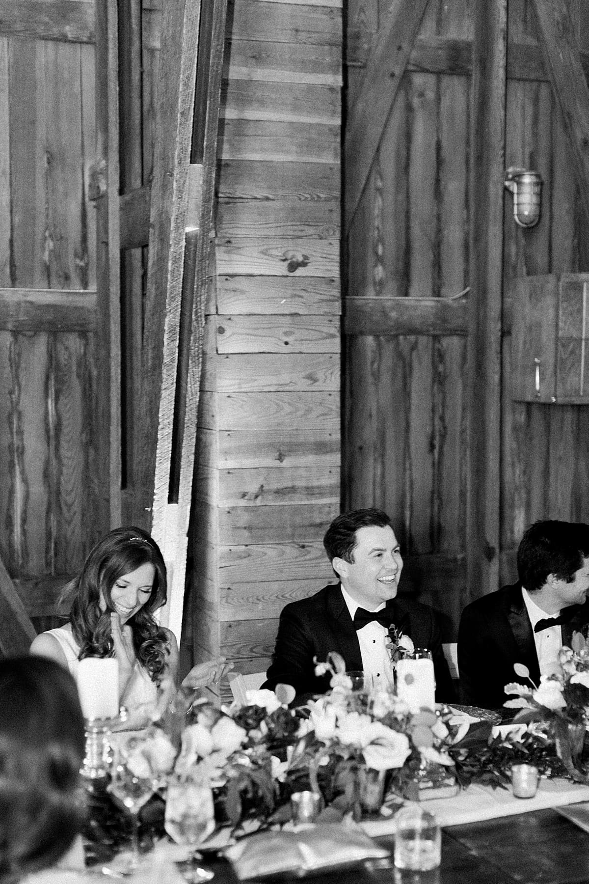  Arielle Peters Photography | Bride and groom laughing at wedding reception on wedding day at St. Joseph's Farm in Granger, Indiana.