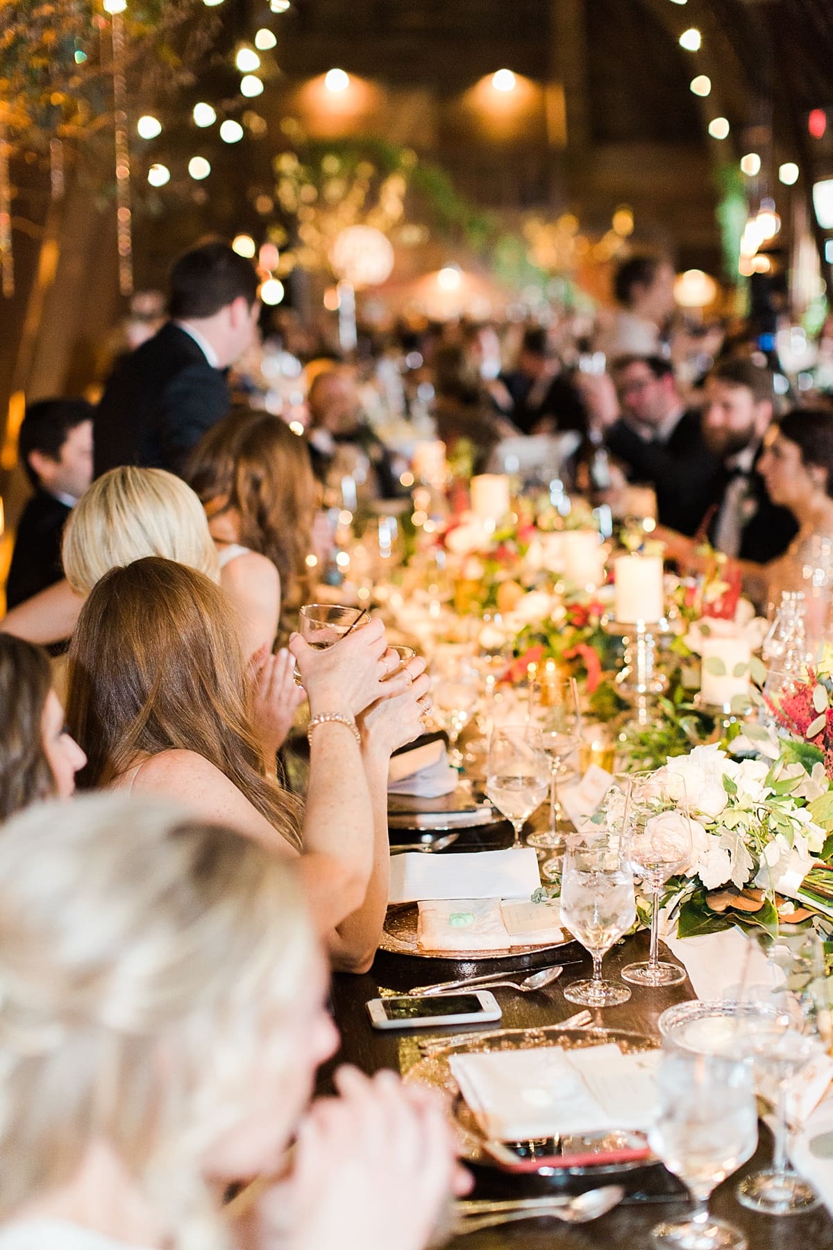  Arielle Peters Photography | Wedding guests raising a glass at wedding reception on wedding day at St. Joseph's Farm in Granger, Indiana.