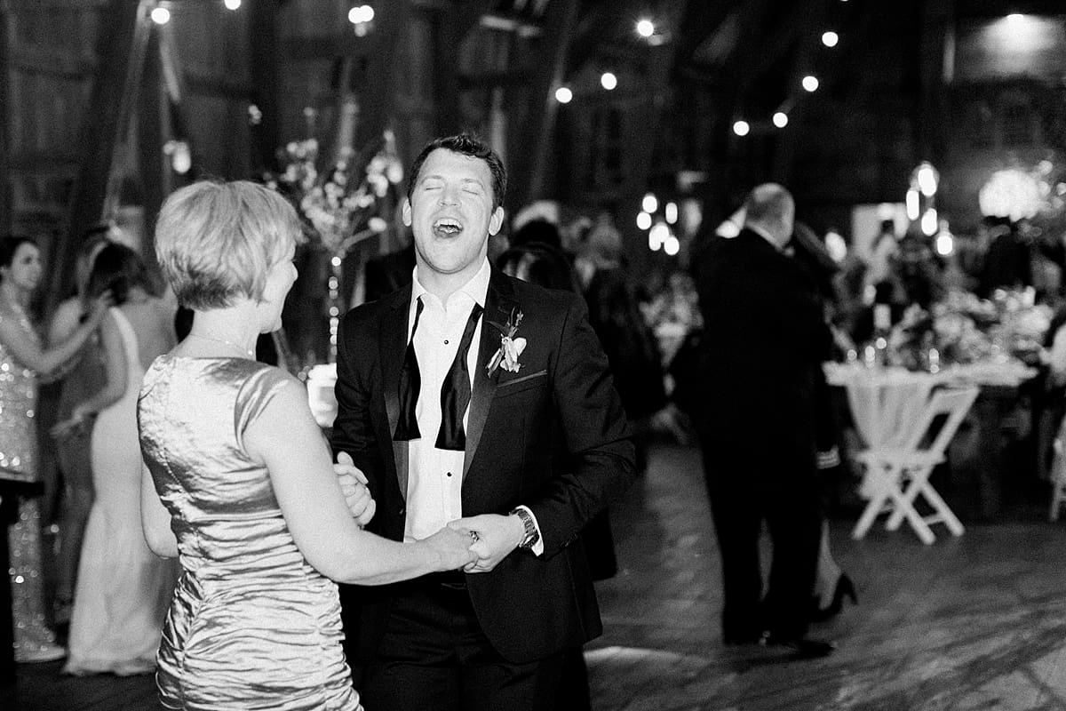  Arielle Peters Photography | Wedding guests dancing and singing at wedding reception on wedding day at St. Joseph's Farm in Granger, Indiana.