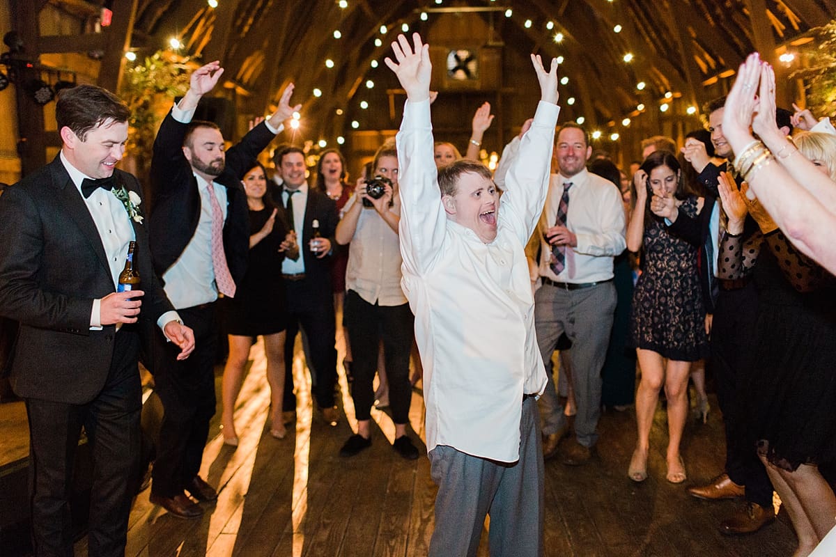  Arielle Peters Photography | Wedding guests dancing at wedding reception on wedding day at St. Joseph's Farm in Granger, Indiana.