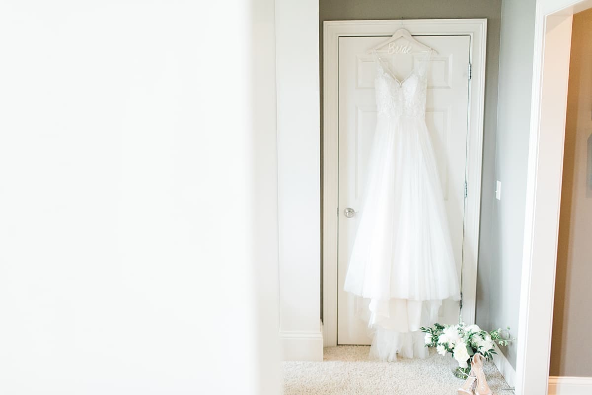 Arielle Peters Photography | Wedding dress hanging in doorway at home on wedding day in Winona Lake, Indiana. 