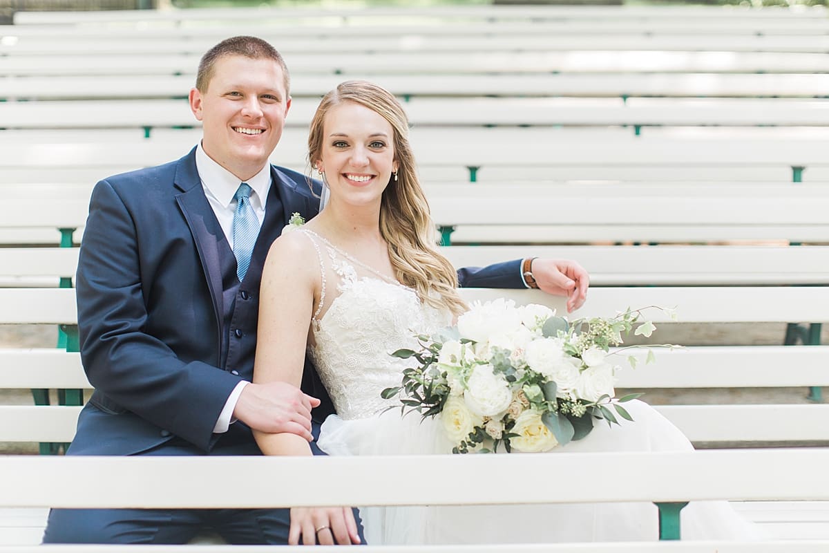 Arielle Peters Photography | Bride and groom sitting on benches on wedding day in Winona Lake, Indiana. 