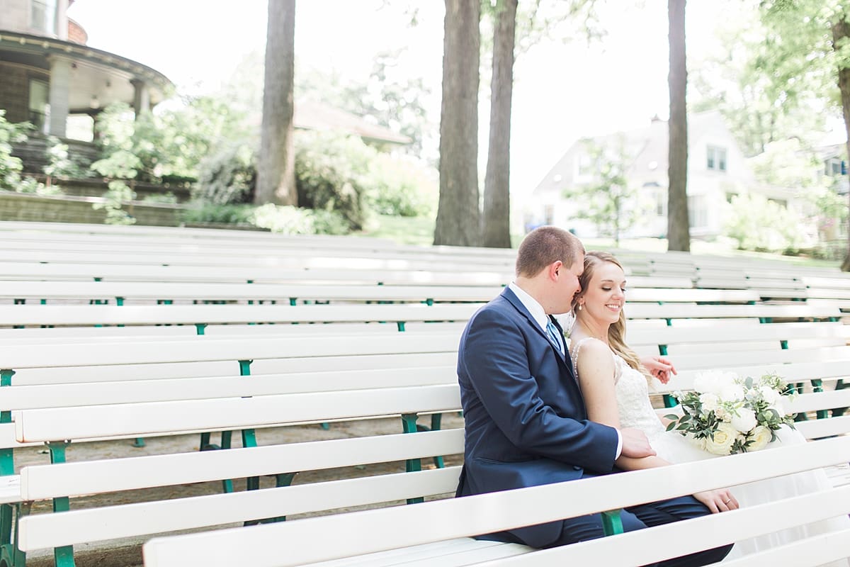 Arielle Peters Photography | Bride and groom sitting on benches on wedding day in Winona Lake, Indiana. 