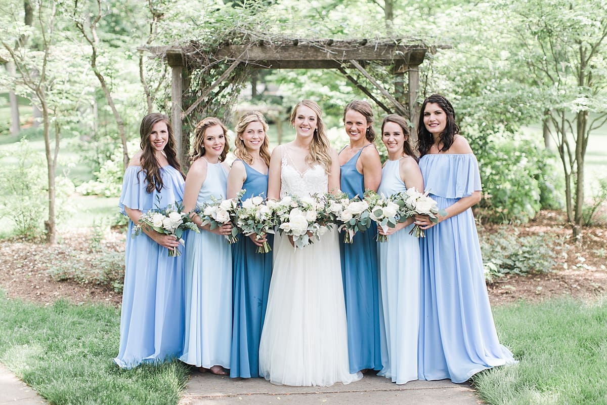 Arielle Peters Photography | Bride and bridesmaids next to over-grown trellis on wedding day in Winona Lake, Indiana. 