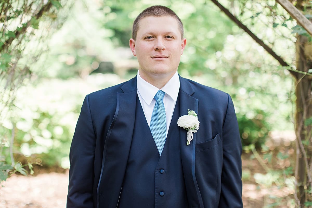 Arielle Peters Photography | Groom under over-grown trellis at home on wedding day in Winona Lake, Indiana. 