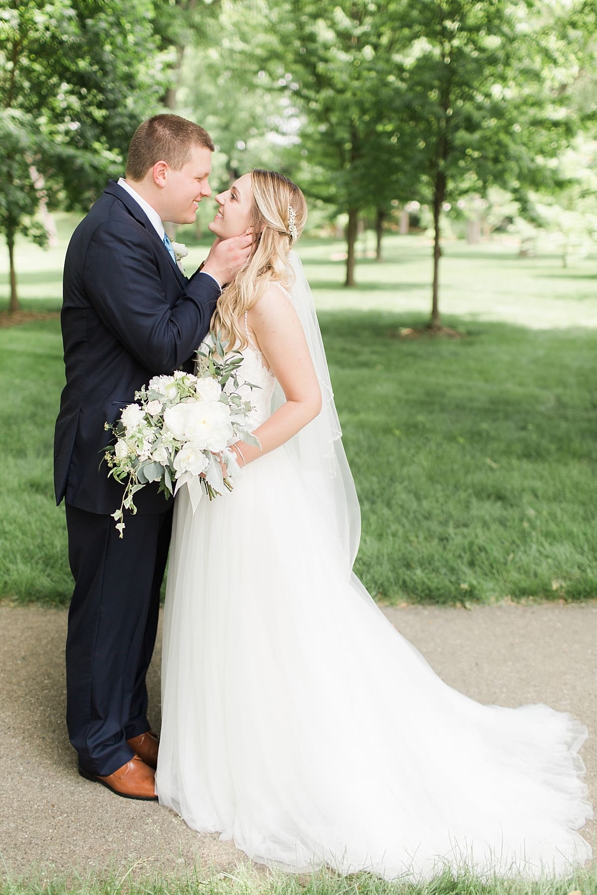 Arielle Peters Photography | Bride and groom under large trees at home on wedding day in Winona Lake, Indiana. 