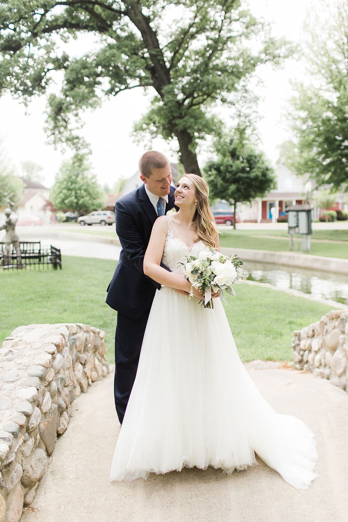 Arielle Peters Photography | Bride and groom on stone bridge on wedding day in Winona Lake, Indiana. 