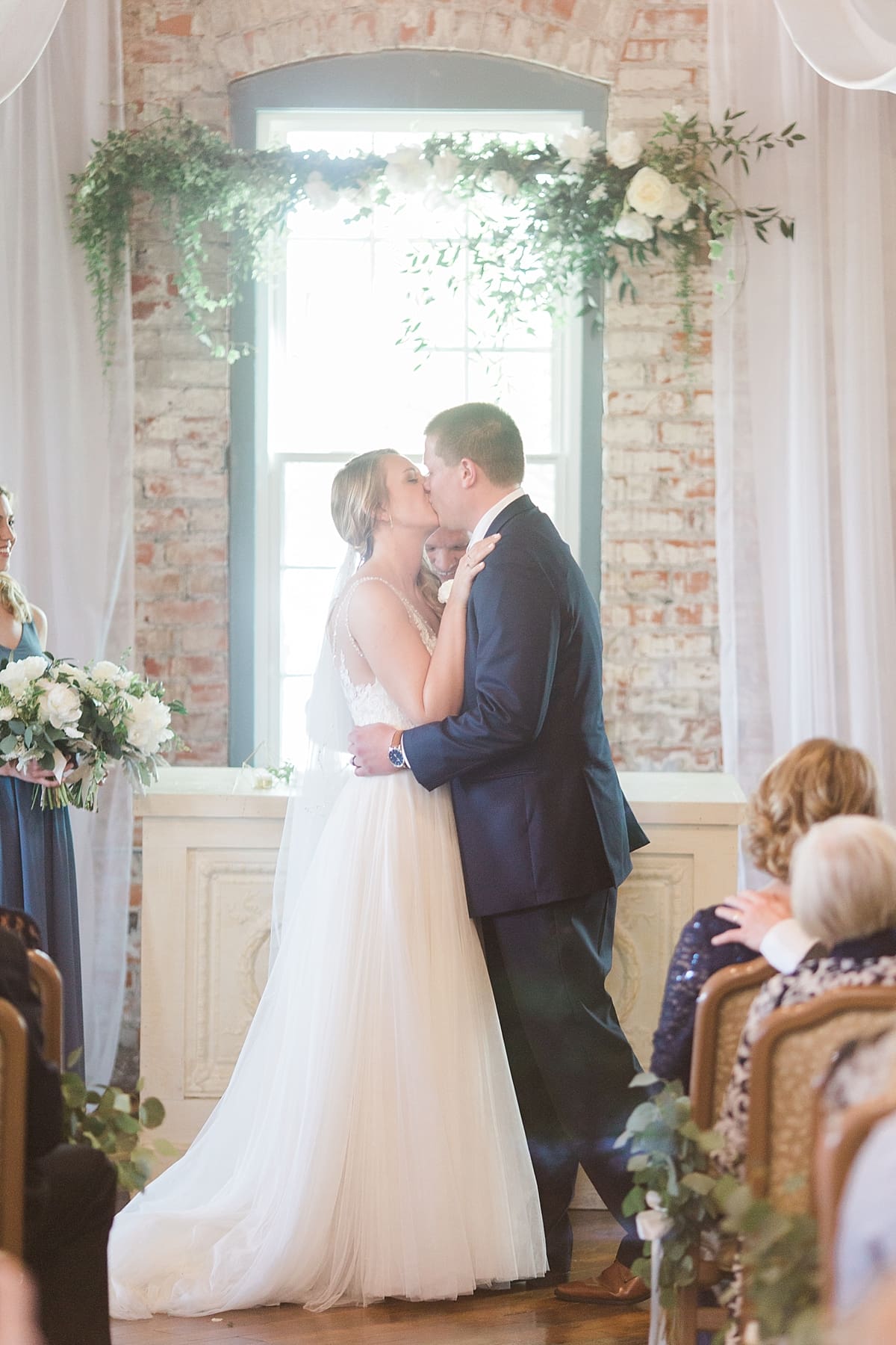 Arielle Peters Photography | Bride and groom kissing at the alter at wedding in Winona Lake, Indiana. 
