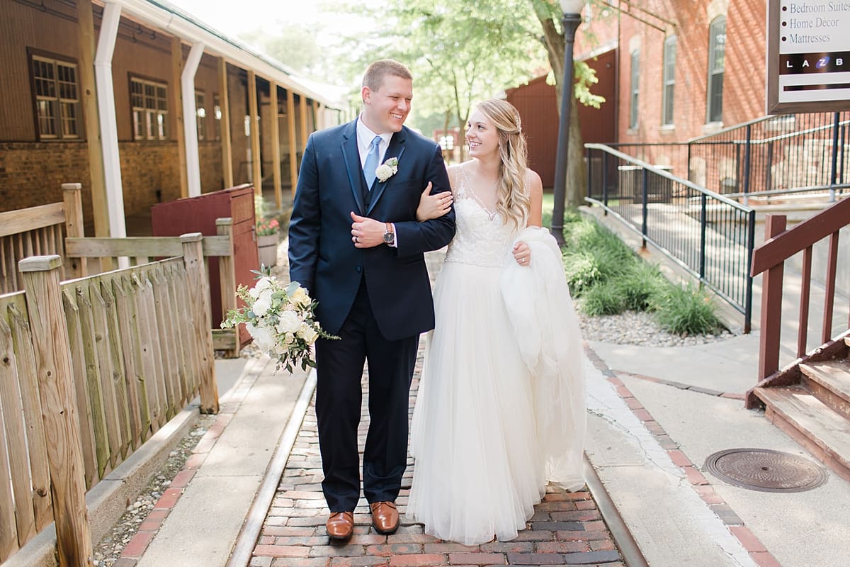 Arielle Peters Photography | Bride and groom walking with linked arms on wedding day at Bread & Chocolate in Goshen, Indiana.