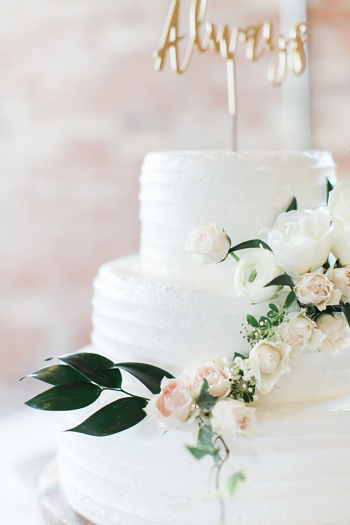Arielle Peters Photography | Wedding reception cake and floral arrangements on wedding day at Bread & Chocolate in Goshen, Indiana.