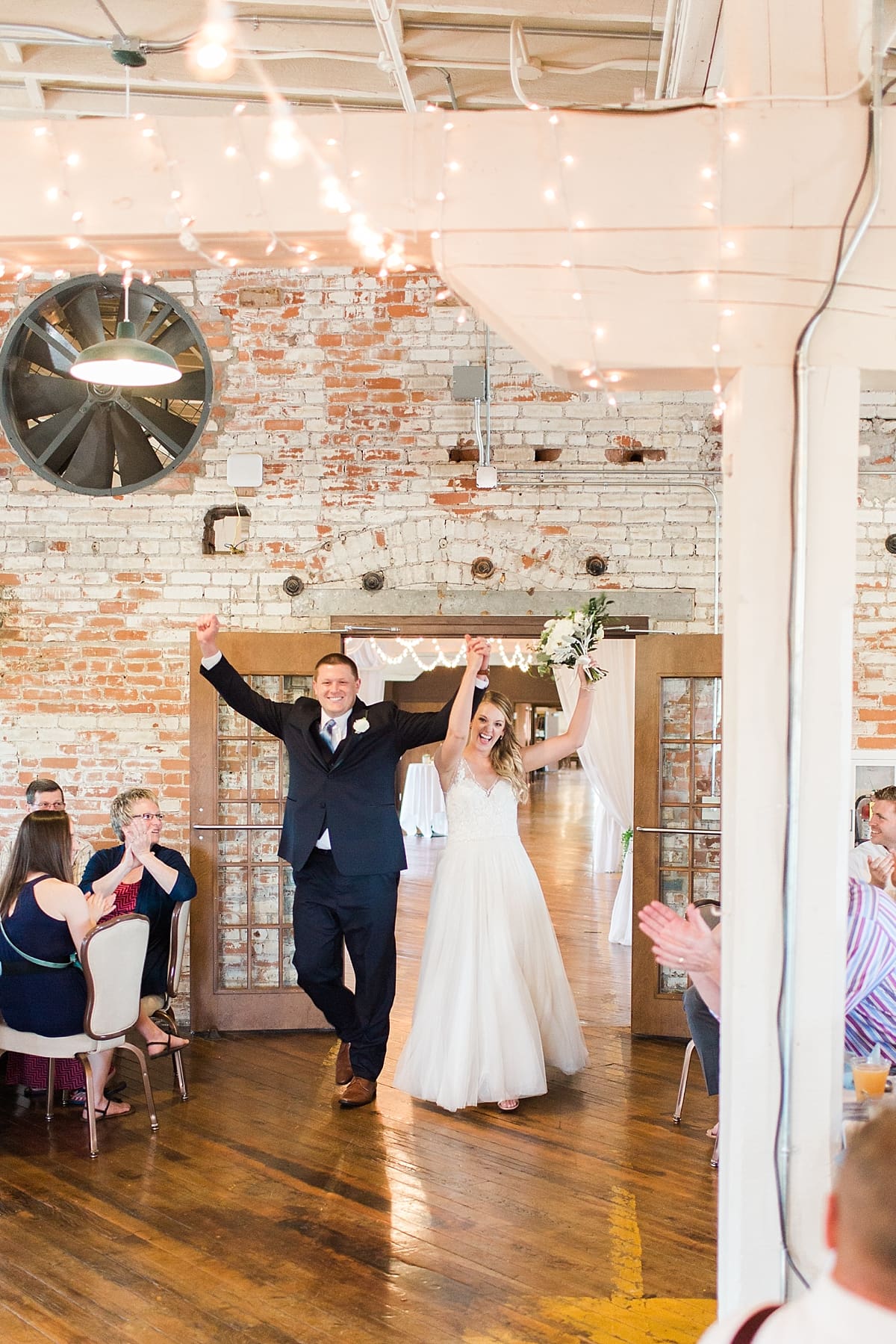 Arielle Peters Photography | Bride and groom entering wedding reception on wedding day at Bread & Chocolate in Goshen, Indiana.
