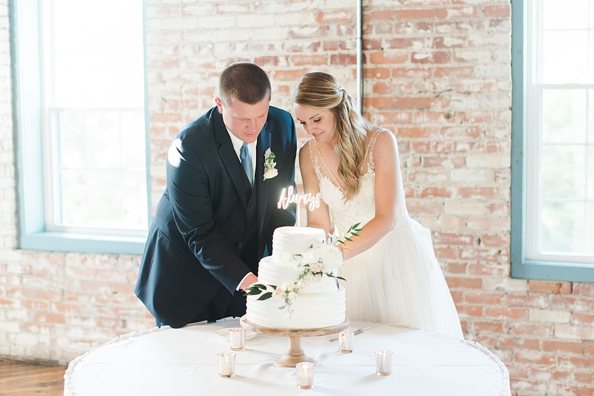 Arielle Peters Photography | Bride and groom cutting cake at wedding reception on wedding day at Bread & Chocolate in Goshen, Indiana.