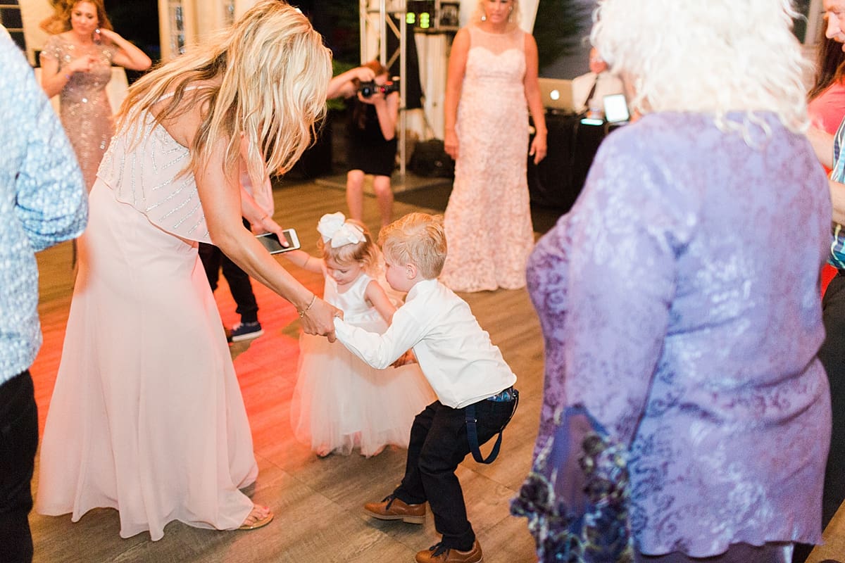  Arielle Peters Photography | Wedding guests dancing at outdoor tent wedding reception on wedding day at The Morris Estate in Niles, Michigan.