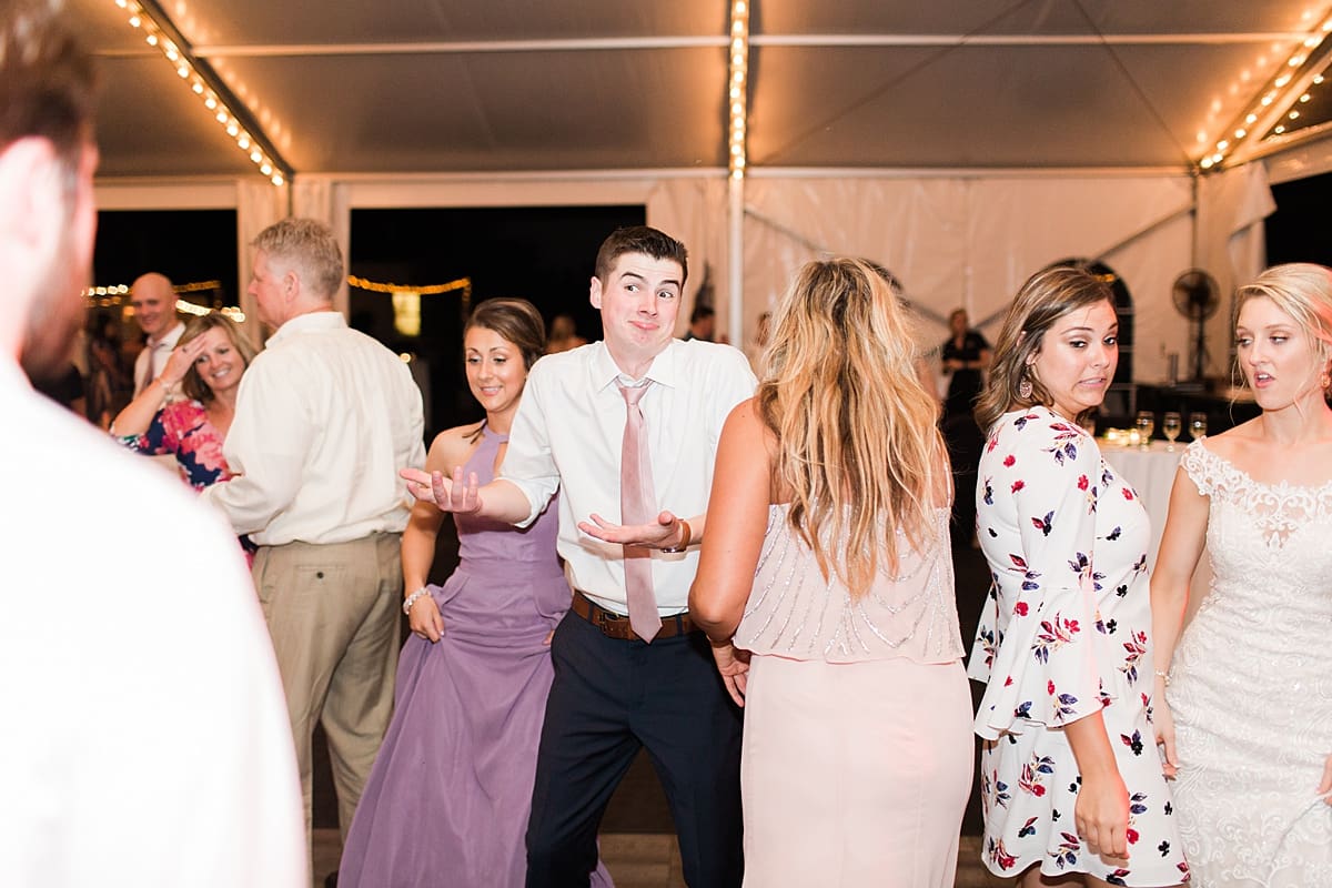  Arielle Peters Photography | Wedding guests dancing at outdoor tent wedding reception on wedding day at The Morris Estate in Niles, Michigan.