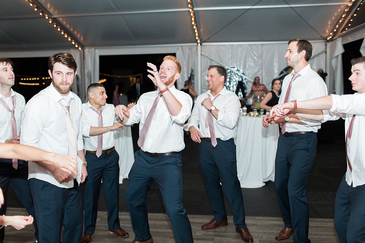  Arielle Peters Photography | Groomsmen dancing at outdoor tent wedding reception on wedding day at The Morris Estate in Niles, Michigan.