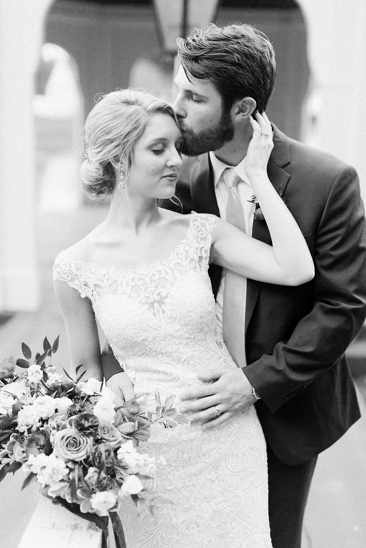  Arielle Peters Photography | Groom holding bride and kissing her on wedding day at The Morris Estate in Niles, Michigan.