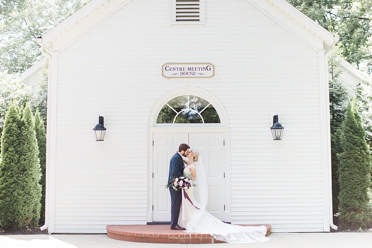  Arielle Peters Photography | Bride and groom kissing outside church steeple on wedding day at The Morris Estate in Niles, Michigan.