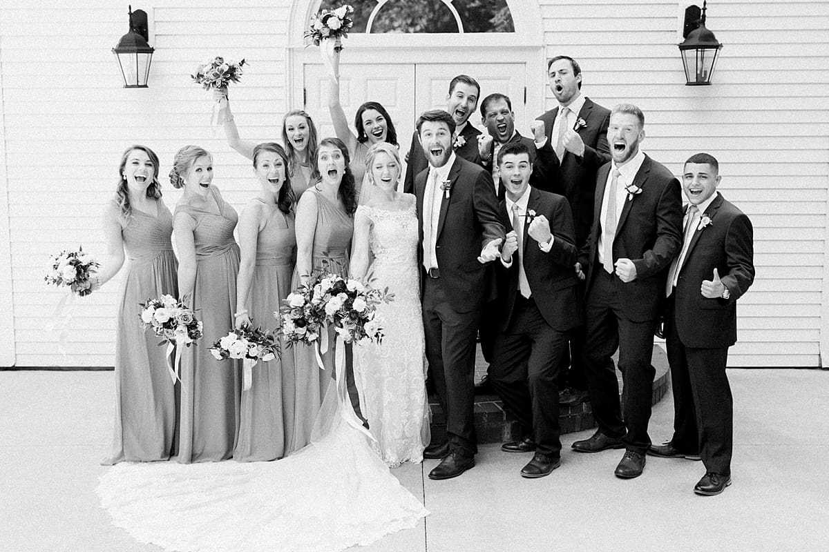  Arielle Peters Photography | Wedding party cheering outside church on wedding day at The Morris Estate in Niles, Michigan.