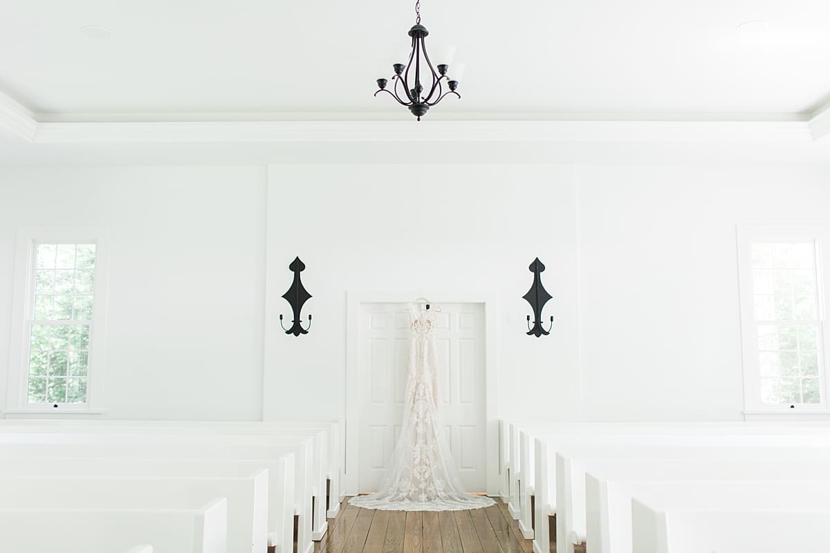 Arielle Peters Photography | Wedding dress hanging in doorway in church on wedding day at The Morris Estate in Niles, Michigan.