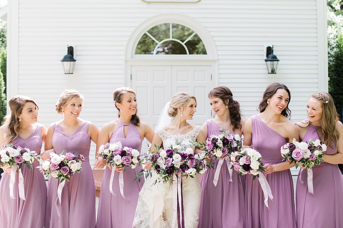  Arielle Peters Photography | Bride and bridesmaids in front of church doors on wedding day at The Morris Estate in Niles, Michigan.