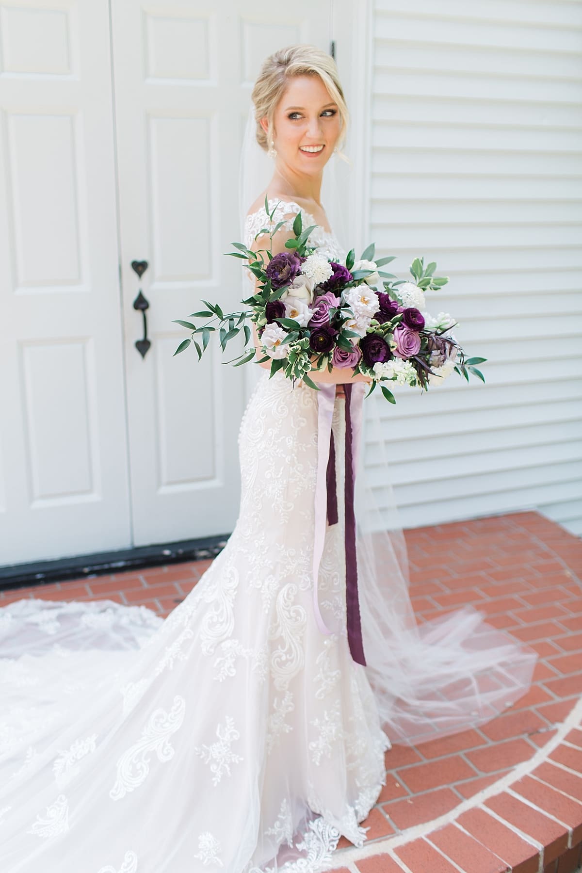  Arielle Peters Photography | Bride holding purple bouquet on wedding day at The Morris Estate in Niles, Michigan.