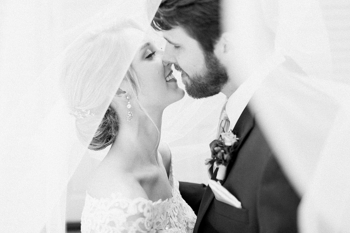  Arielle Peters Photography | Bride and groom almost kissing under veil on wedding day at The Morris Estate in Niles, Michigan.