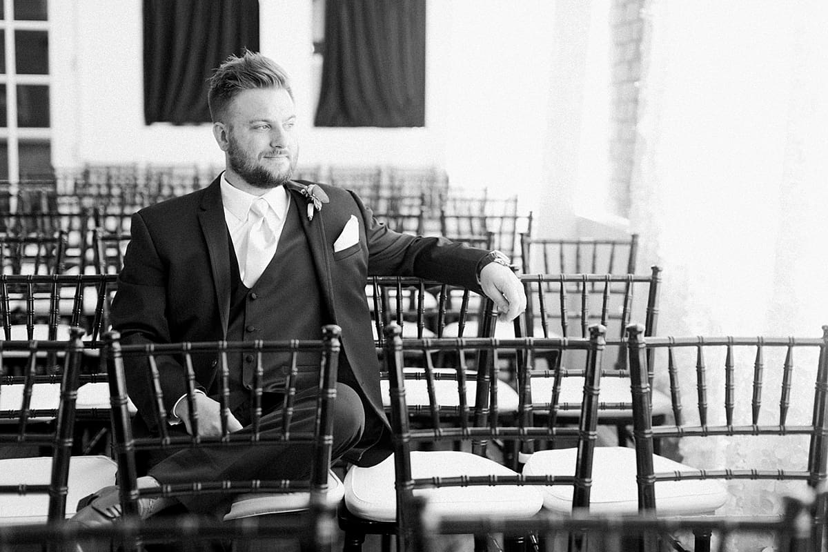 Arielle Peters Photography | Groom sitting in chairs at The Allure in LaPorte, Indiana on wedding day.