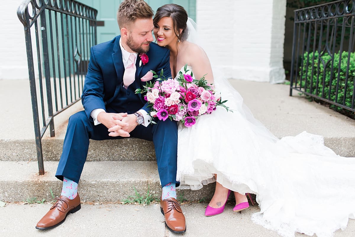 Arielle Peters Photography | Bride and groom sitting in front of turquoise doors at The Allure in LaPorte, Indiana on wedding day.