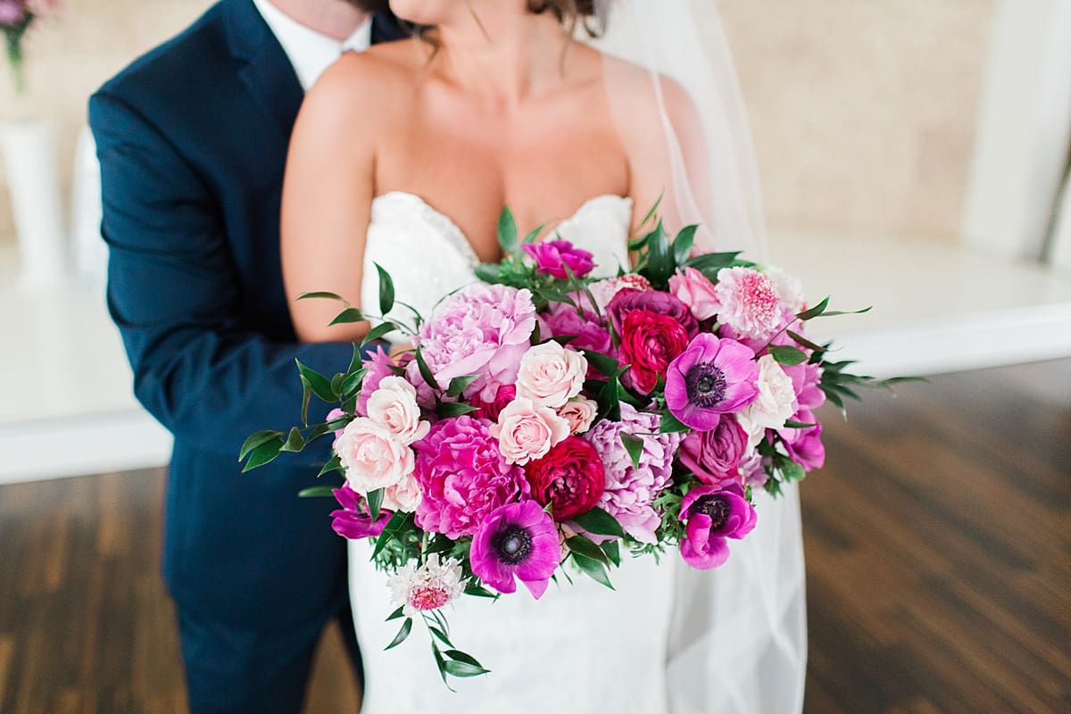 Arielle Peters Photography | Bride and groom holding bright bouquet at The Allure in LaPorte, Indiana on wedding day.