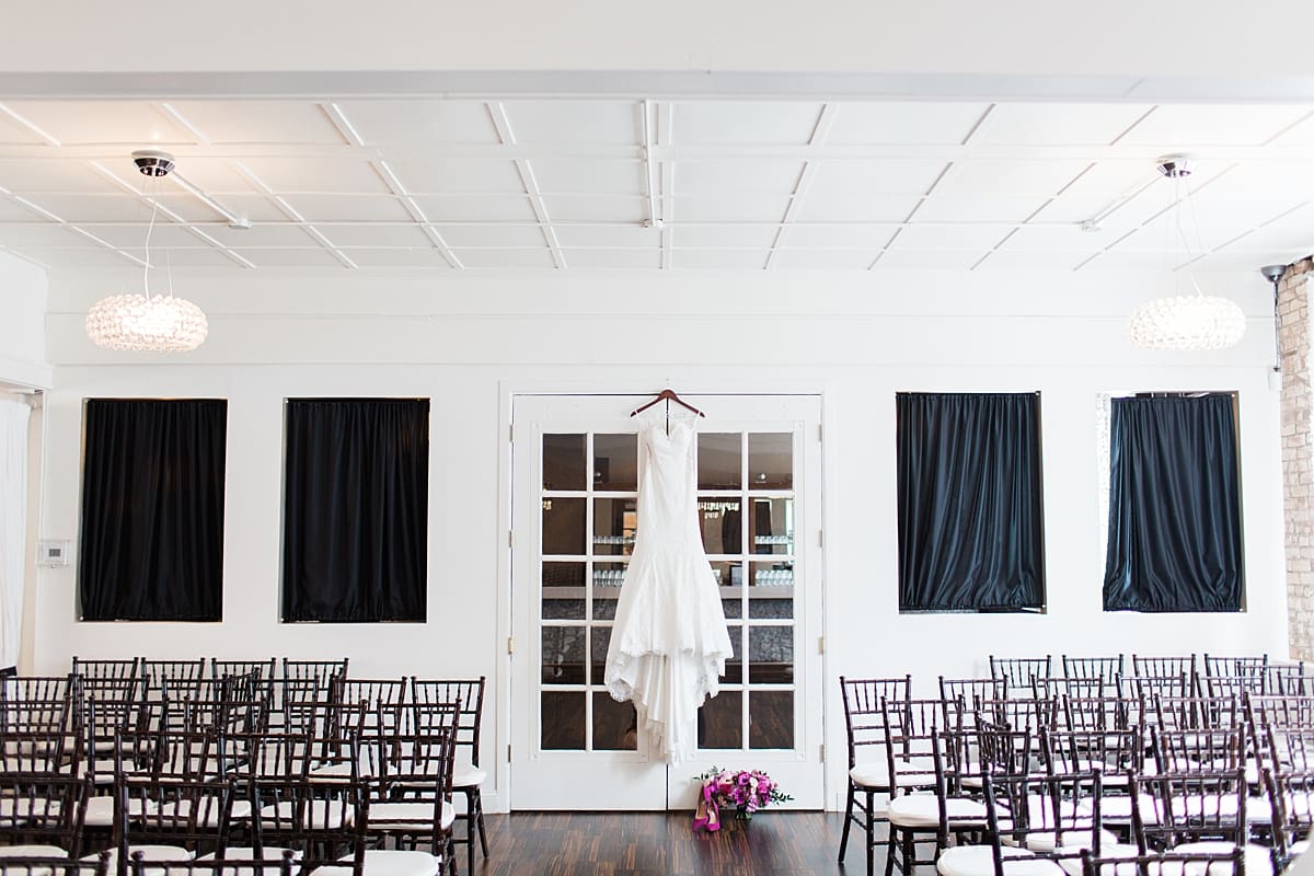 Arielle Peters Photography | Wedding gown hanging in front of french doors on wedding day at The Allure in LaPorte, Indiana.