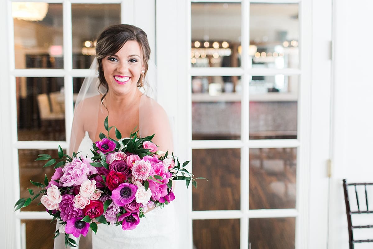 Arielle Peters Photography | Bride holding bouquet in front of french doors at The Allure in LaPorte, Indiana on wedding day.