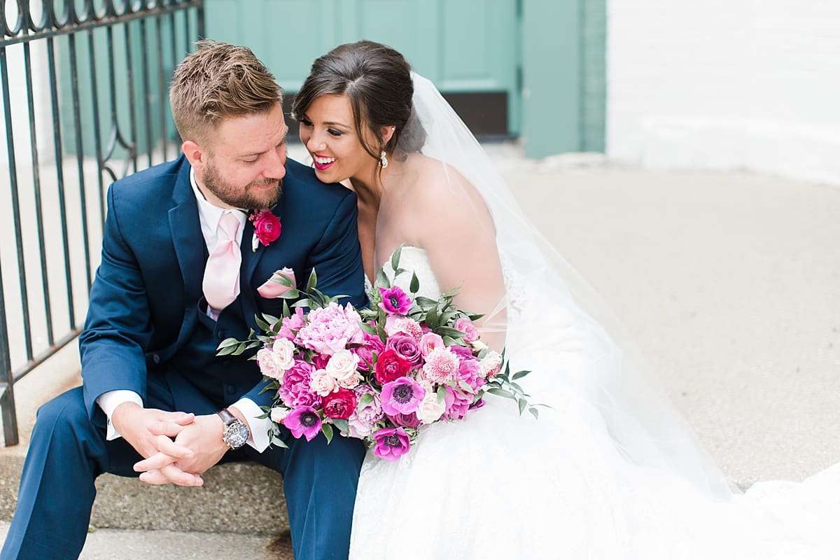 Arielle Peters Photography | Bride and groom sitting in front of turquoise doors at The Allure in LaPorte, Indiana on wedding day.