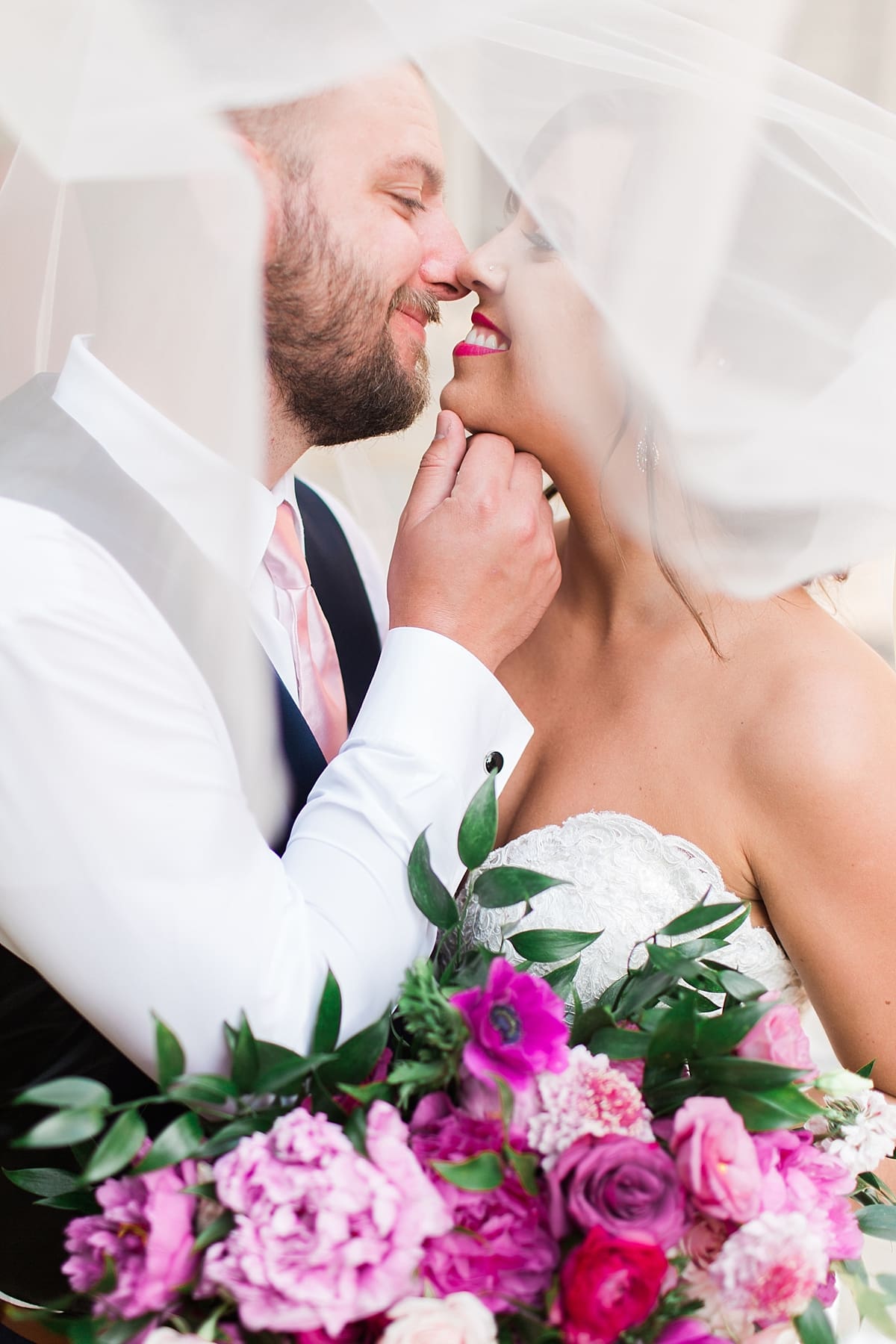 Arielle Peters Photography | Bride and groom kissing under veil at The Allure in LaPorte, Indiana on wedding day.