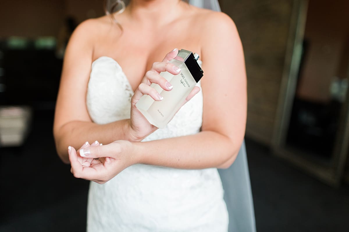 Arielle Peters Photography | Bride putting on perfume on wedding day at The Allure in LaPorte, Indiana.