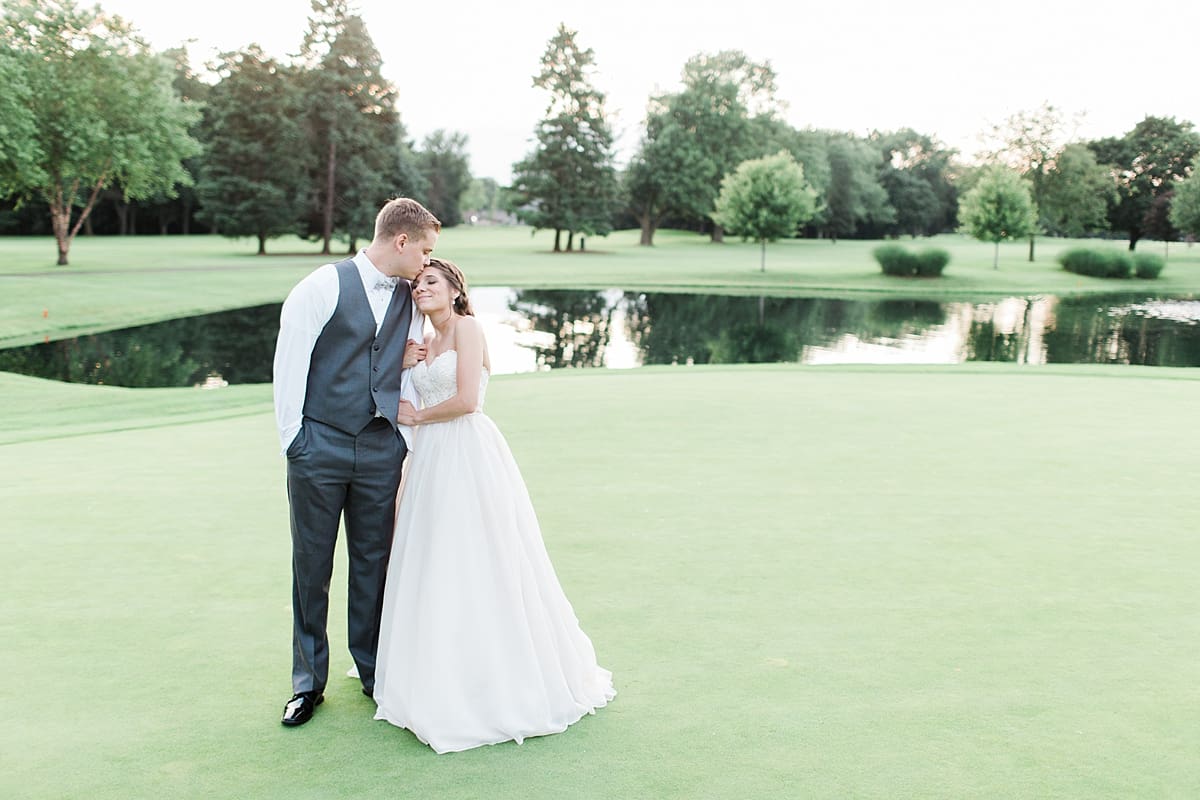 Arielle Peters Photography | Bride and groom on golf course next to pond on wedding day at Morris Park Country Club in South Bend, Indiana.