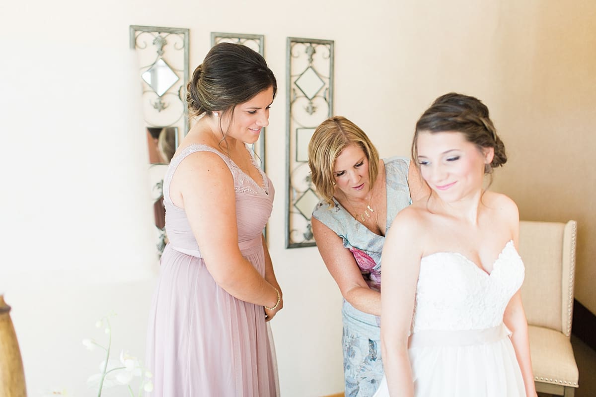 Arielle Peters Photography | Mother of the bride helping bride get dressed on wedding day at Morris Park Country Club in South Bend, Indiana.