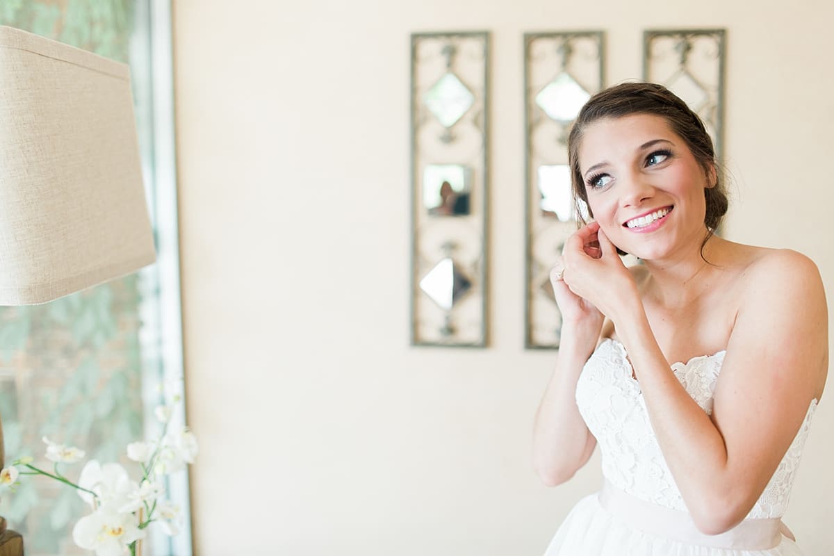 Arielle Peters Photography | Bride putting on jewelry on wedding day at Morris Park Country Club in South Bend, Indiana.