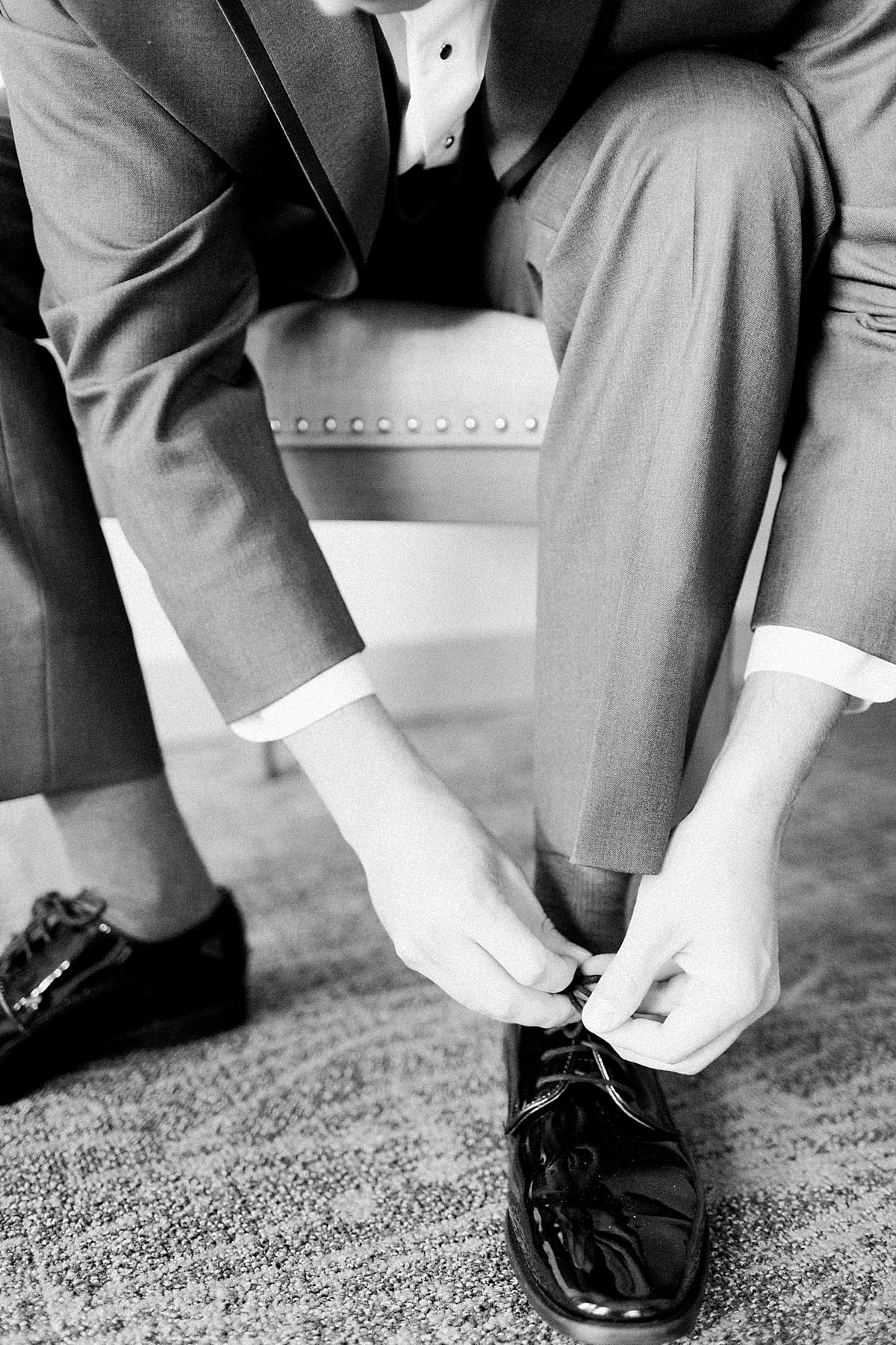 Arielle Peters Photography | Groom tying his shoes on wedding day at Morris Park Country Club in South Bend, Indiana.
