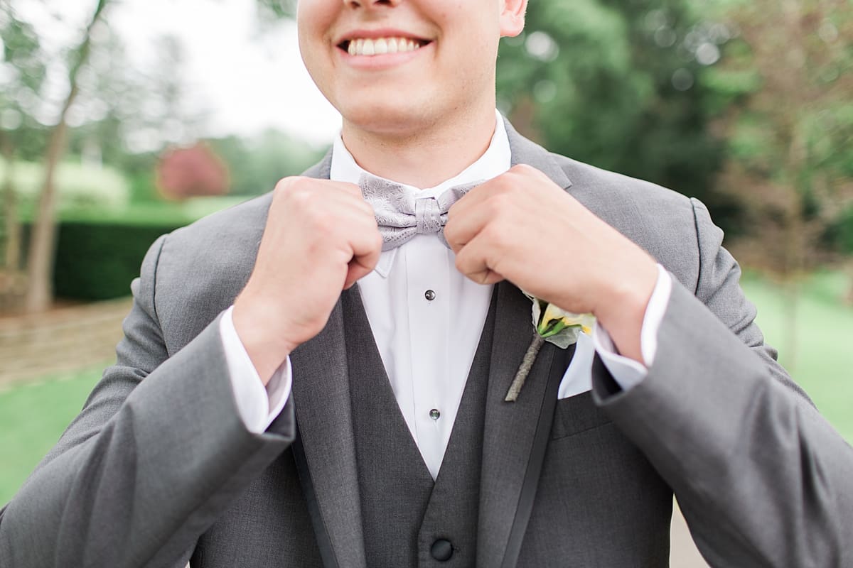 Arielle Peters Photography | Groom adjusting his bowtie on wedding day at Morris Park Country Club in South Bend, Indiana.