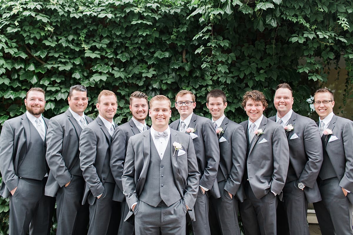 Arielle Peters Photography | Groom and groomsmen by ivy wall on wedding day at Morris Park Country Club in South Bend, Indiana.