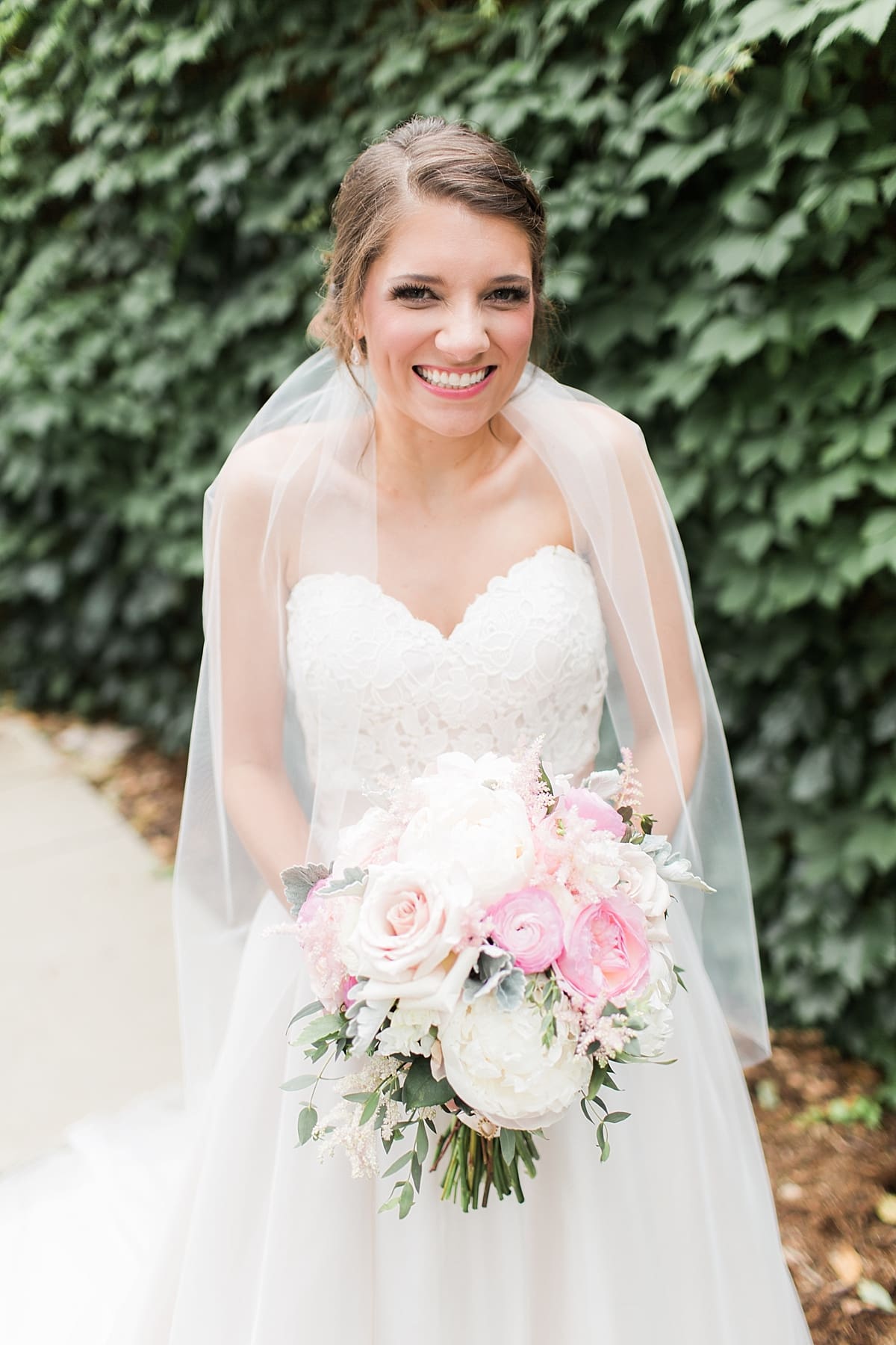 Arielle Peters Photography | Bride standing by ivy-covered wall on wedding day at Morris Park Country Club in South Bend, Indiana.