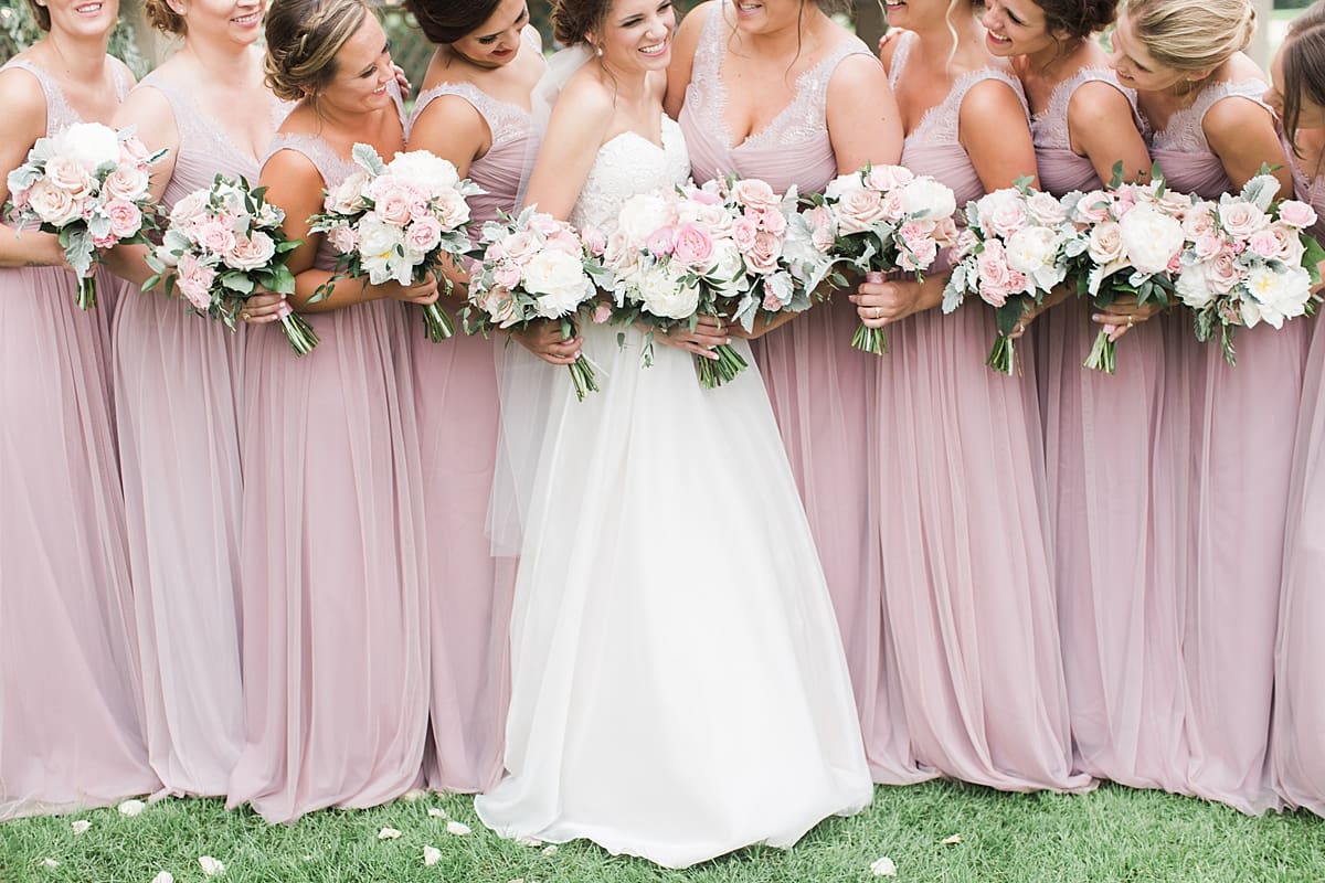 Arielle Peters Photography | Bride and bridesmaids by ivy-covered wall on wedding day at Morris Park Country Club in South Bend, Indiana.