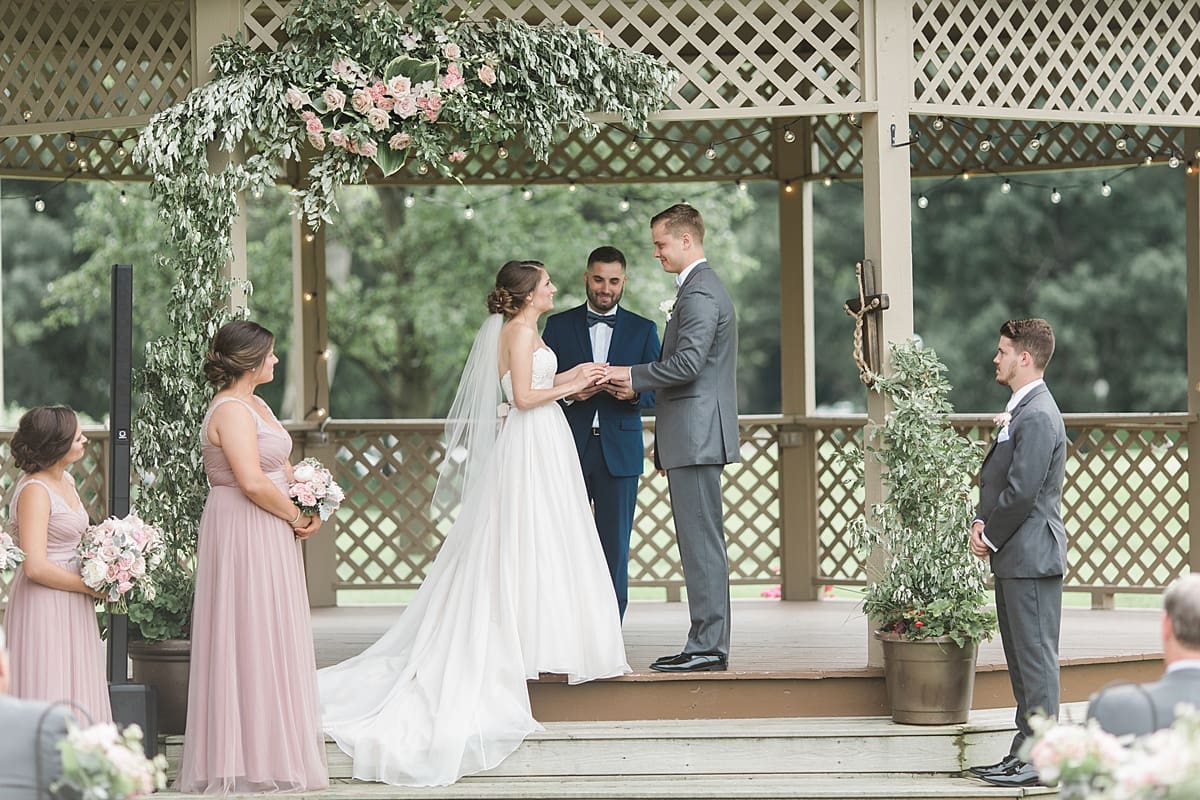 Arielle Peters Photography | Bride and groom holding hands at alter on wedding day at Morris Park Country Club in South Bend, Indiana.
