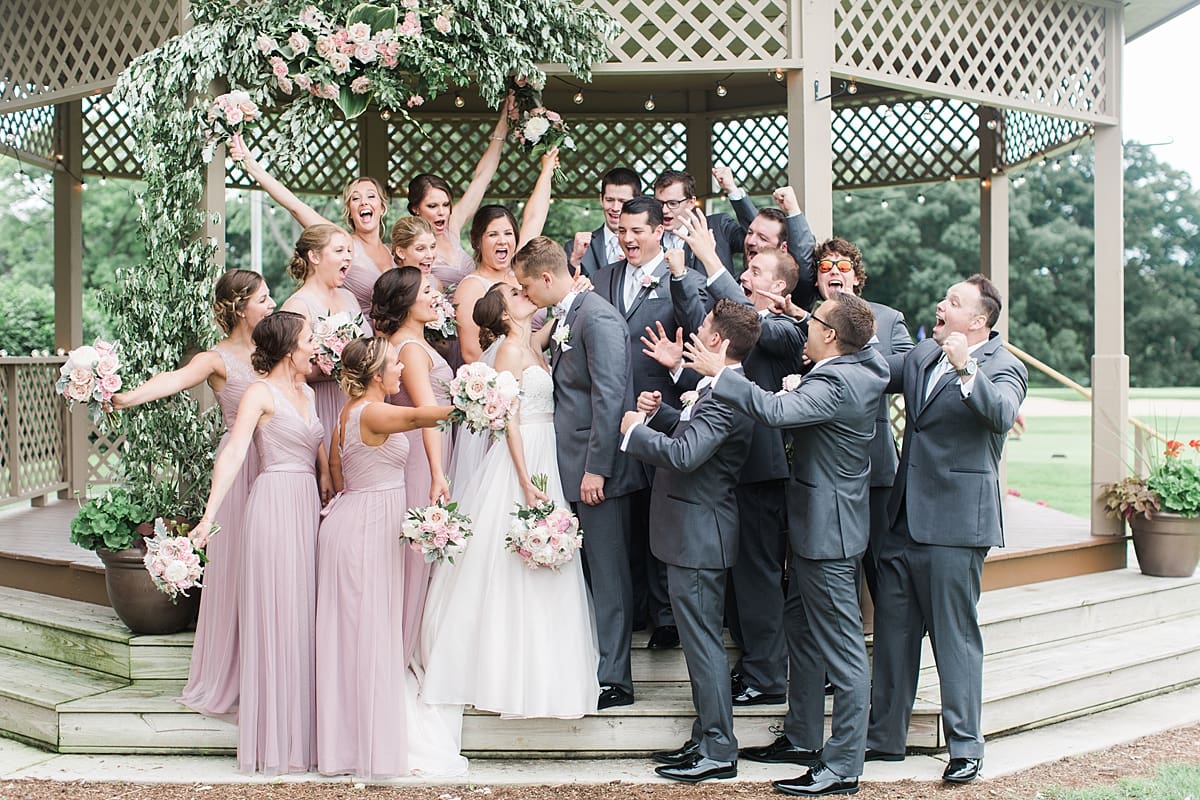 Arielle Peters Photography | Wedding party cheering under gazebo on wedding day at Morris Park Country Club in South Bend, Indiana.