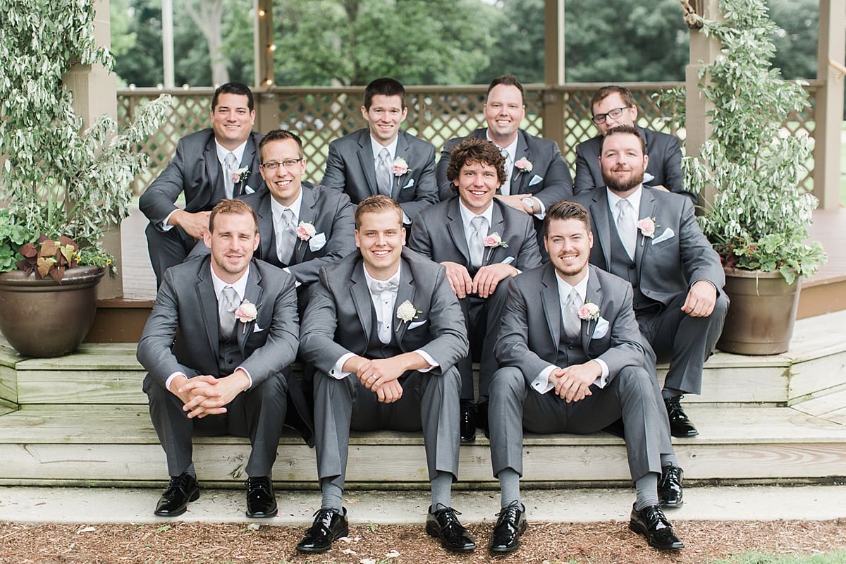 Arielle Peters Photography | Groom and groomsmen sitting on gazebo steps on wedding day at Morris Park Country Club in South Bend, Indiana.
