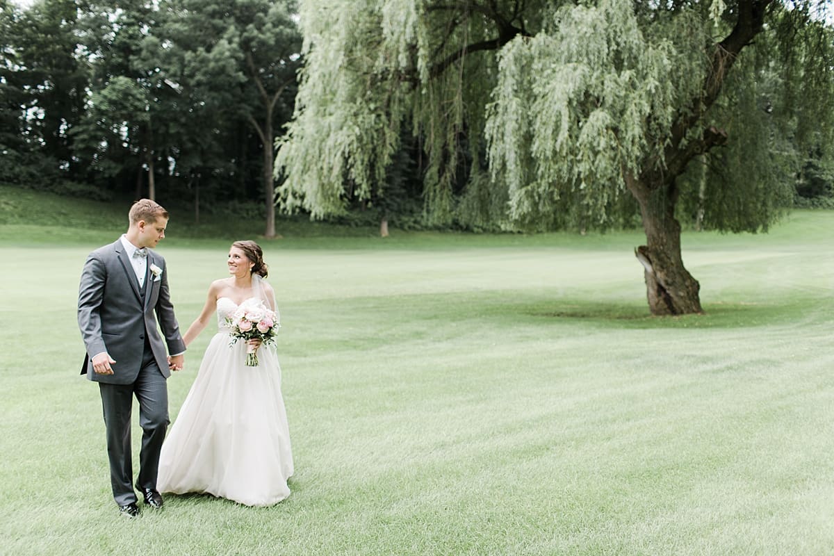 Arielle Peters Photography | Bride and groom walking on golf course on wedding day at Morris Park Country Club in South Bend, Indiana.